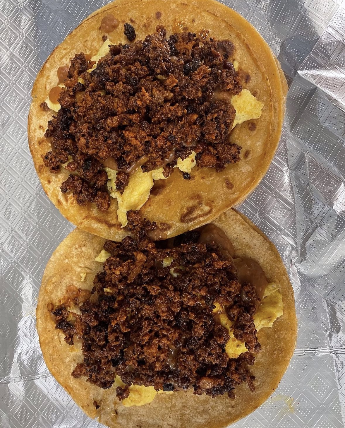 Breakfast chorizo and egg tacos on corn tortillas